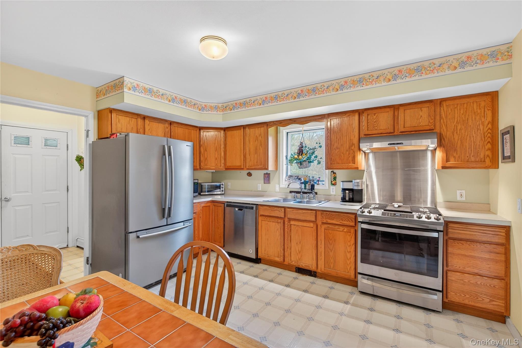 1044 Blue Mountain Road Saugerties, NY 12477 - Photo 12 of 32 a kitchen with stainless steel appliances granite countertop a refrigerator sink and stove