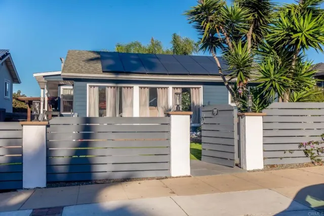 a view of a house with a small yard and plants