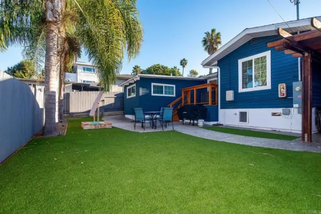 a front view of house with yard and outdoor seating