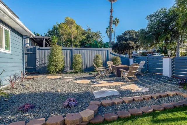 a view of backyard with a table and chairs