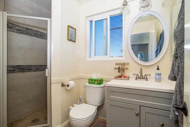 a bathroom with a sink a toilet and shower