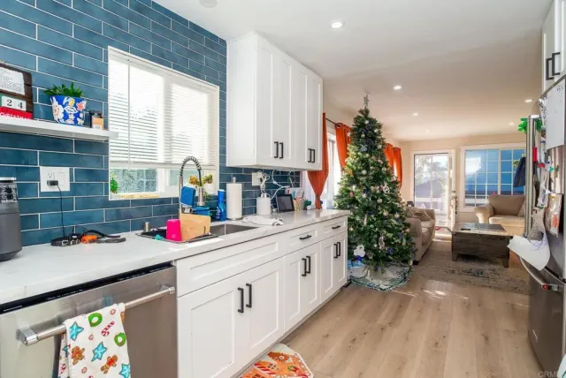 a view of a kitchen that has a lot of cabinets and couch