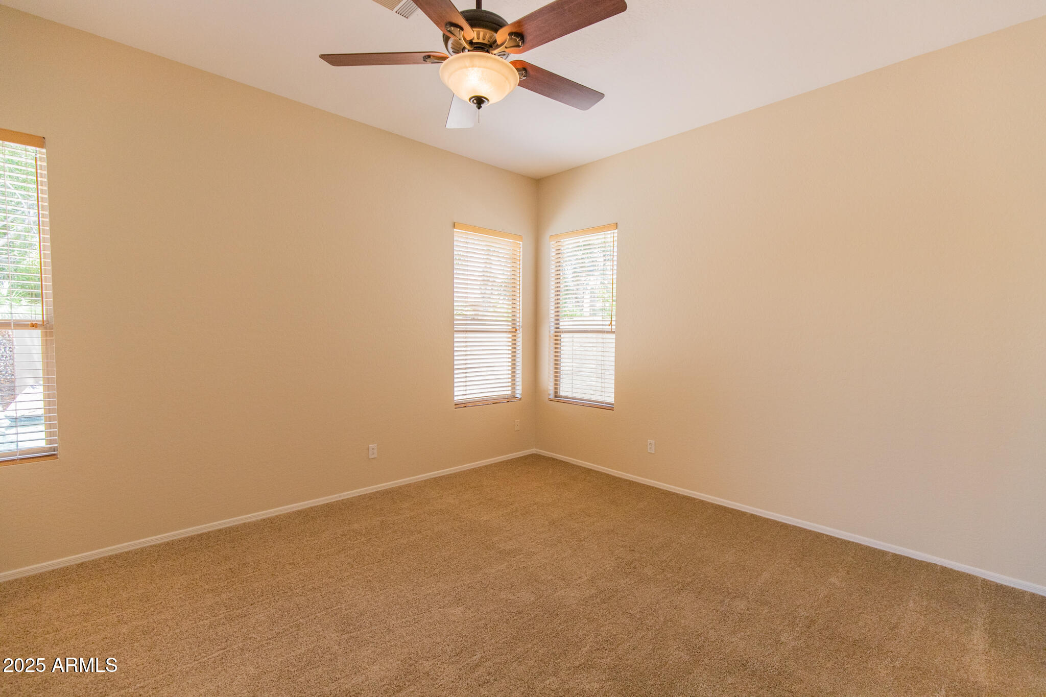 770 West Aloe Place Chandler, AZ 85248 - Photo 12 of 28 an empty room with a window and a fan