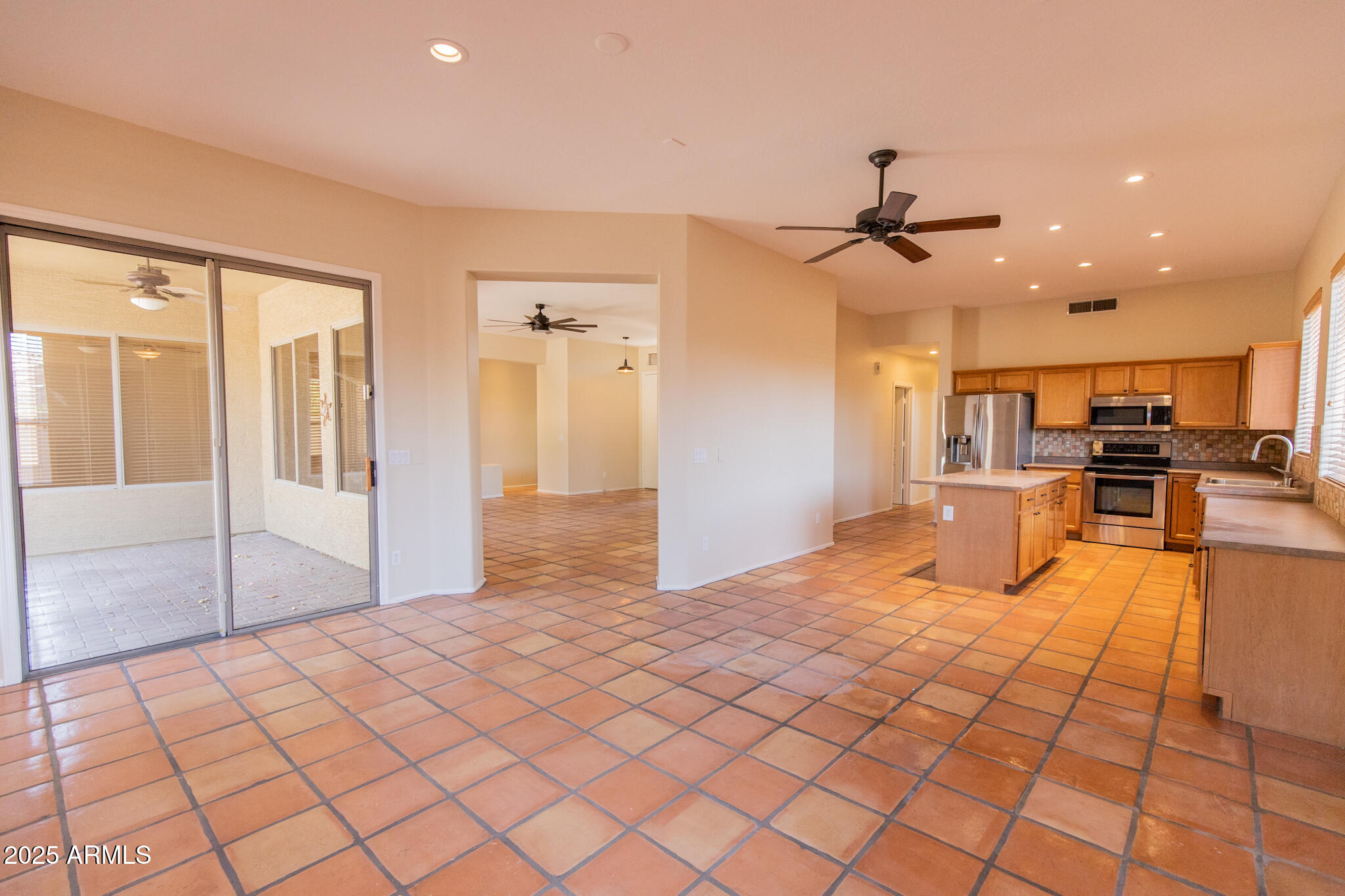 770 West Aloe Place Chandler, AZ 85248 - Photo 6 of 28 a view of a kitchen with kitchen island granite countertop a refrigerator and a sink