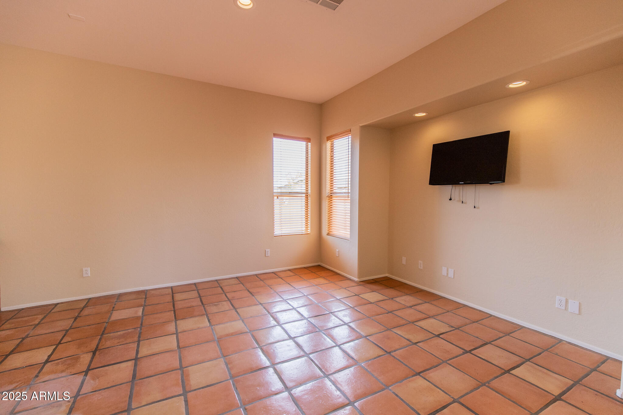 770 West Aloe Place Chandler, AZ 85248 - Photo 7 of 28 a view of an empty room with a window and a flat screen tv