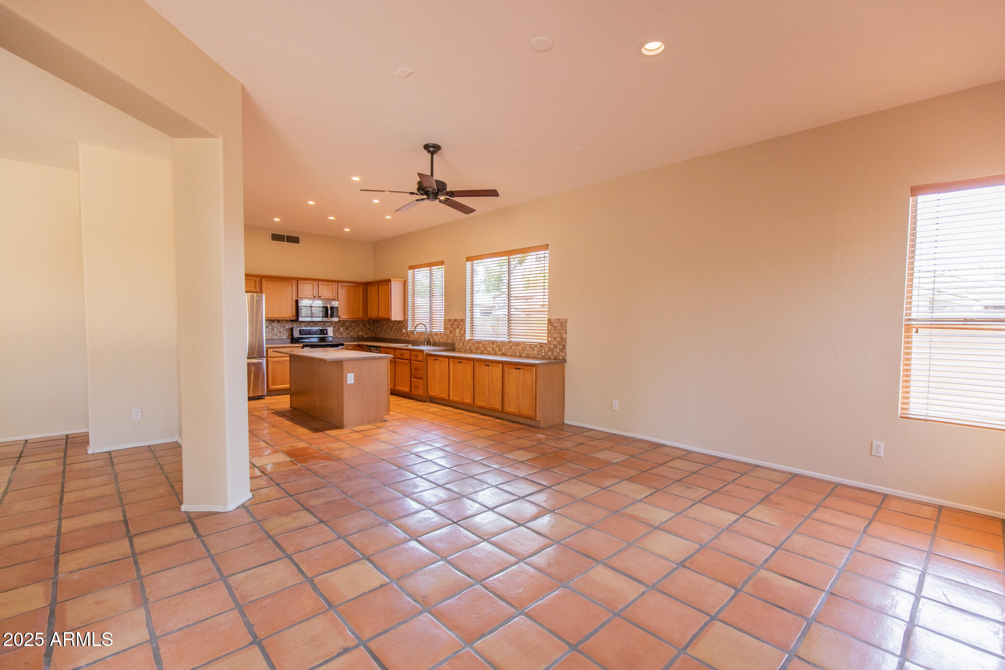 770 West Aloe Place Chandler, AZ 85248 - Photo 8 of 28 a view of a kitchen with kitchen island granite countertop a refrigerator cabinets and a sink