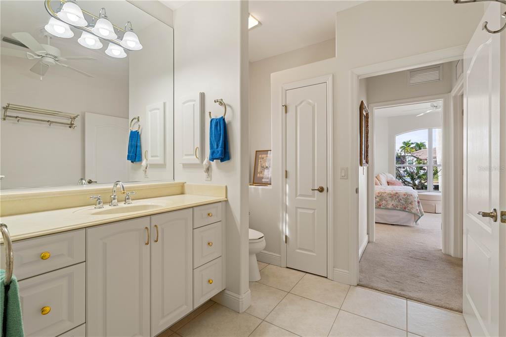 2736 Mayaguana Court Punta Gorda, FL 33950 - Photo 51 of 80 a spacious bathroom with a granite countertop sink a toilet and a mirror