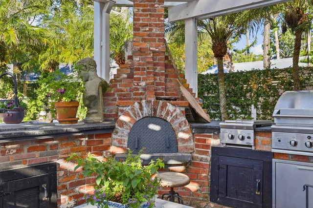 a kitchen with stainless steel appliances a sink stove and cabinets