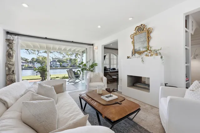 a living room with furniture and view of kitchen