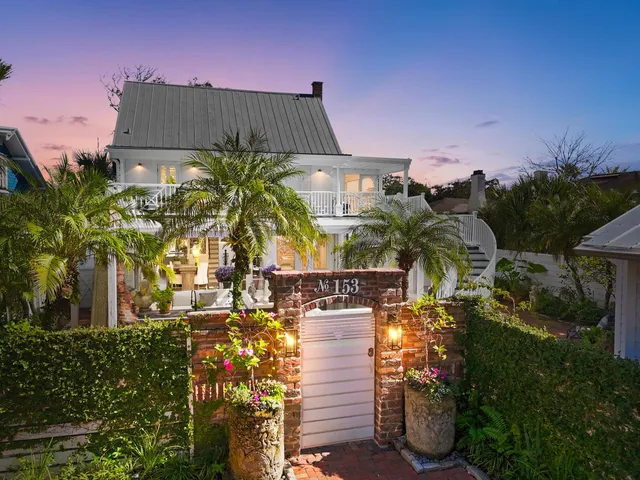 a living room with furniture a large window and a potted plant