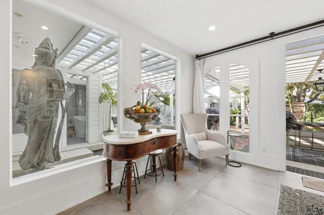 a living room with furniture and a painting on the wall