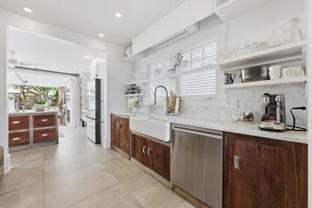 a view of a patio with a table and chairs and potted plants