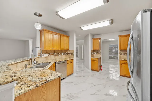 a kitchen with a refrigerator stove and microwave