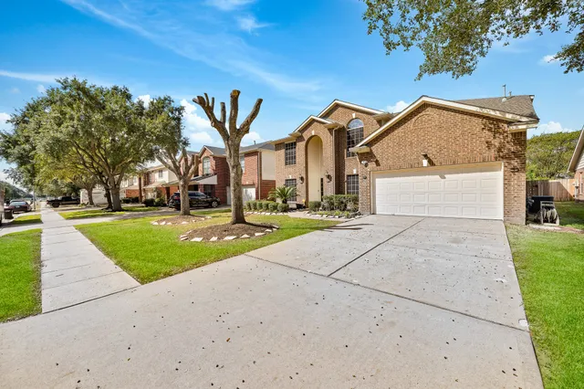 a view of a white house with a yard
