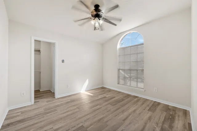 a view of an empty room with a ceiling fan