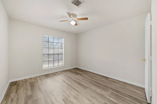 a view of room with hardwood floor and ceiling fan