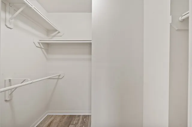 a spacious bathroom with a tub sink and mirror