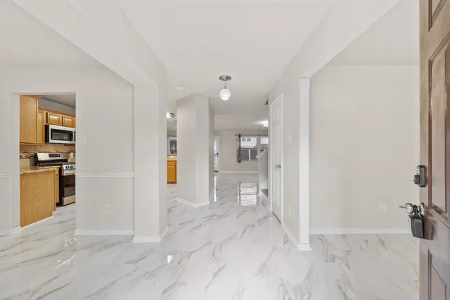 a view of a kitchen with a refrigerator and a sink