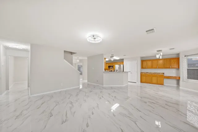 a large kitchen with stainless steel appliances granite countertop a granite counter tops and a window