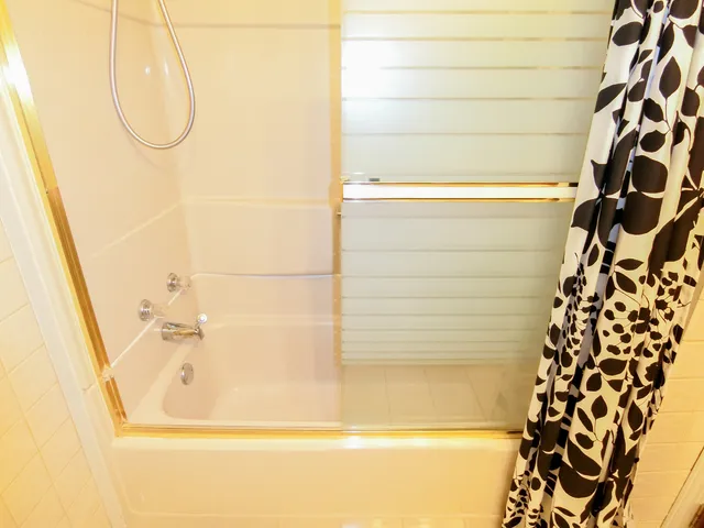 a bathroom with a bathtub and shower