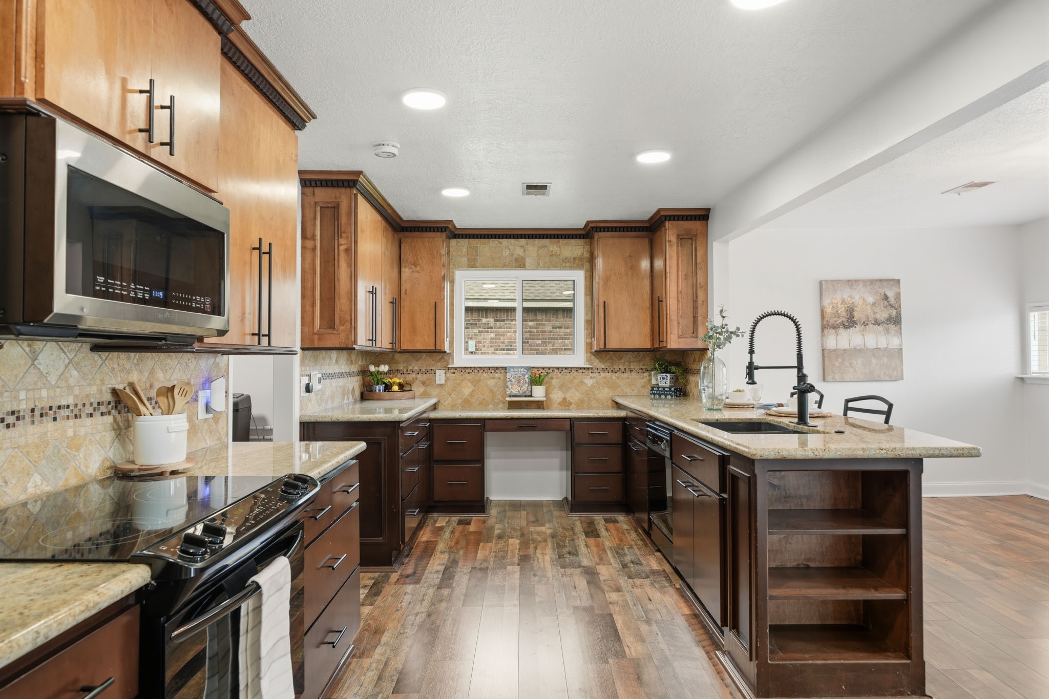 79 Summers Wind Street Conroe, TX 77356 - Photo 14 of 45 a kitchen with a sink stove top oven and cabinets