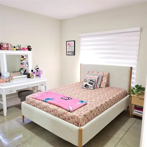 a bedroom with a bed and a dresser