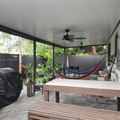 a view of a porch with a table and chairs