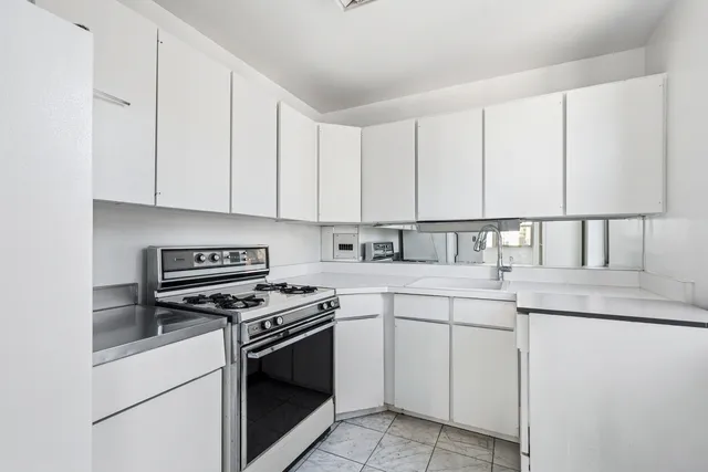 a view of a kitchen with a sink and cabinets