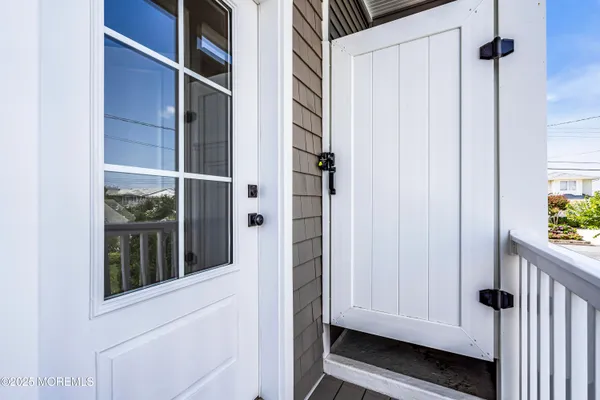 a bathroom with a toilet a sink a mirror and a shower