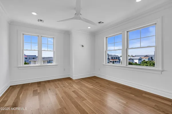 a front view of a house with a yard and potted plants