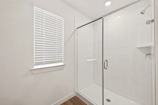 a bathroom with a shower and a window