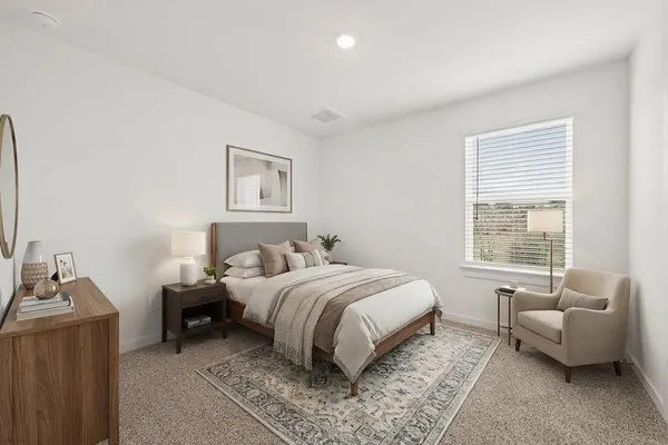 a bedroom with a bed and a couch