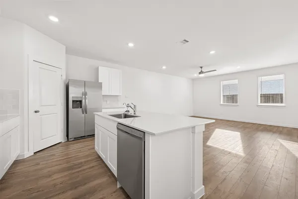 a kitchen with stainless steel appliances granite countertop a sink stove and refrigerator