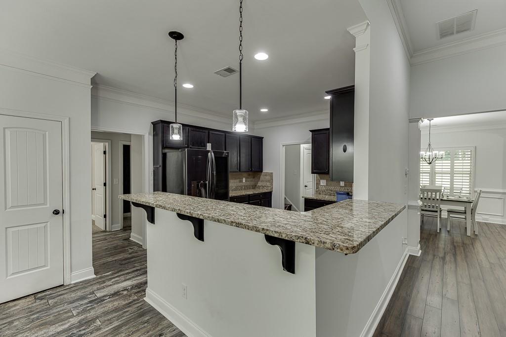 2858 Shadowstone Way Winder, GA 30680 - Photo 16 of 52 a large kitchen with kitchen island a large island in it