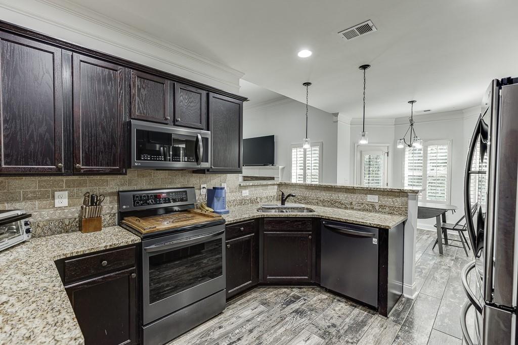 2858 Shadowstone Way Winder, GA 30680 - Photo 19 of 52 a kitchen with a sink stove and microwave