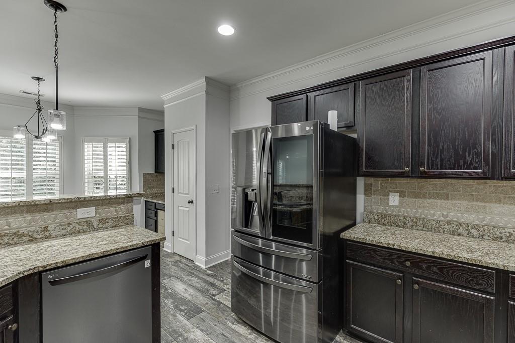 2858 Shadowstone Way Winder, GA 30680 - Photo 21 of 52 a kitchen with granite countertop a refrigerator and a sink