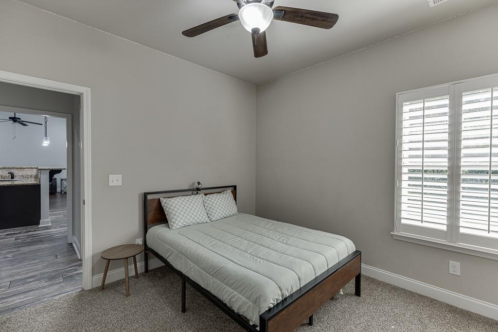 2858 Shadowstone Way Winder, GA 30680 - Photo 23 of 52 a bedroom with a bed and a chandelier