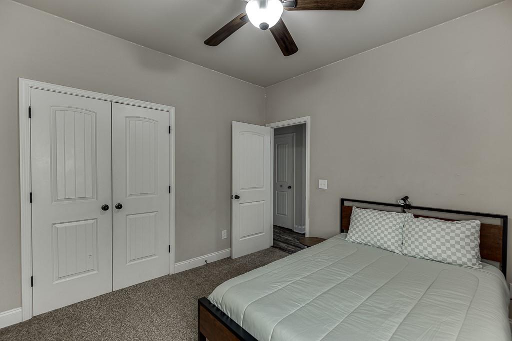 2858 Shadowstone Way Winder, GA 30680 - Photo 24 of 52 a bedroom with a bed and ceiling fan