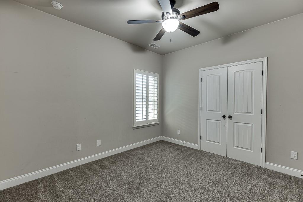 2858 Shadowstone Way Winder, GA 30680 - Photo 26 of 52 an empty room with windows and fan