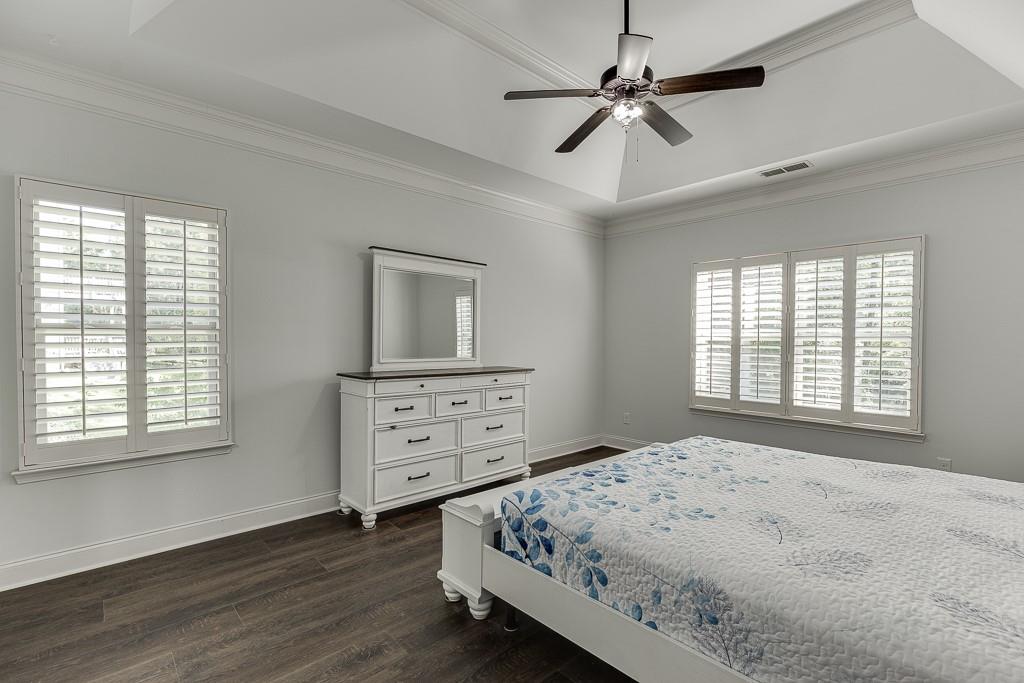 2858 Shadowstone Way Winder, GA 30680 - Photo 32 of 52 a bedroom with a bed a chandelier and a window