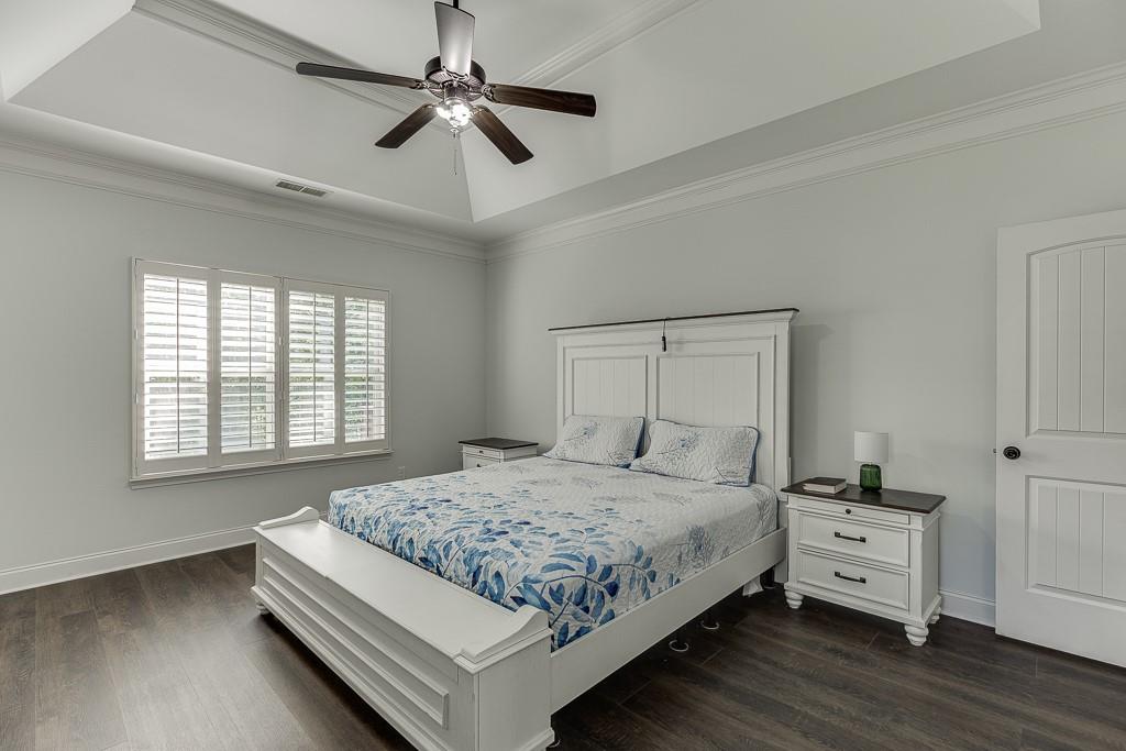 2858 Shadowstone Way Winder, GA 30680 - Photo 33 of 52 a bedroom with a bed and a chandelier
