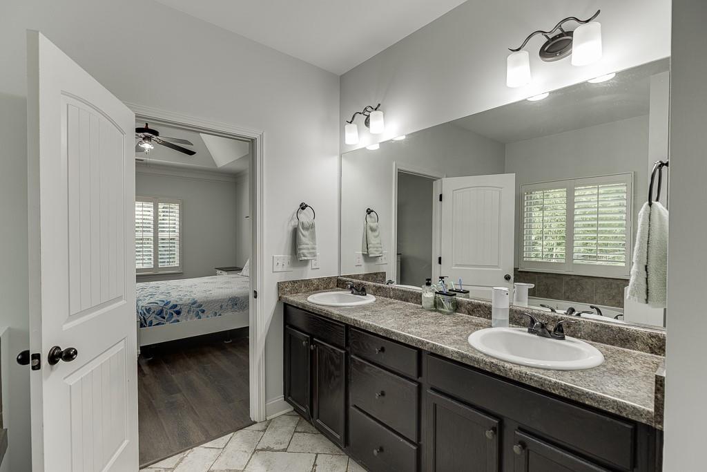 2858 Shadowstone Way Winder, GA 30680 - Photo 37 of 52 a en suite bathroom with double sink and a mirror