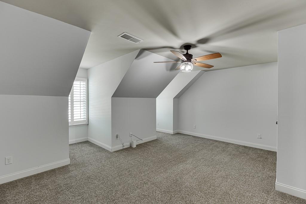 2858 Shadowstone Way Winder, GA 30680 - Photo 39 of 52 a view of an empty room with a ceiling fan and window