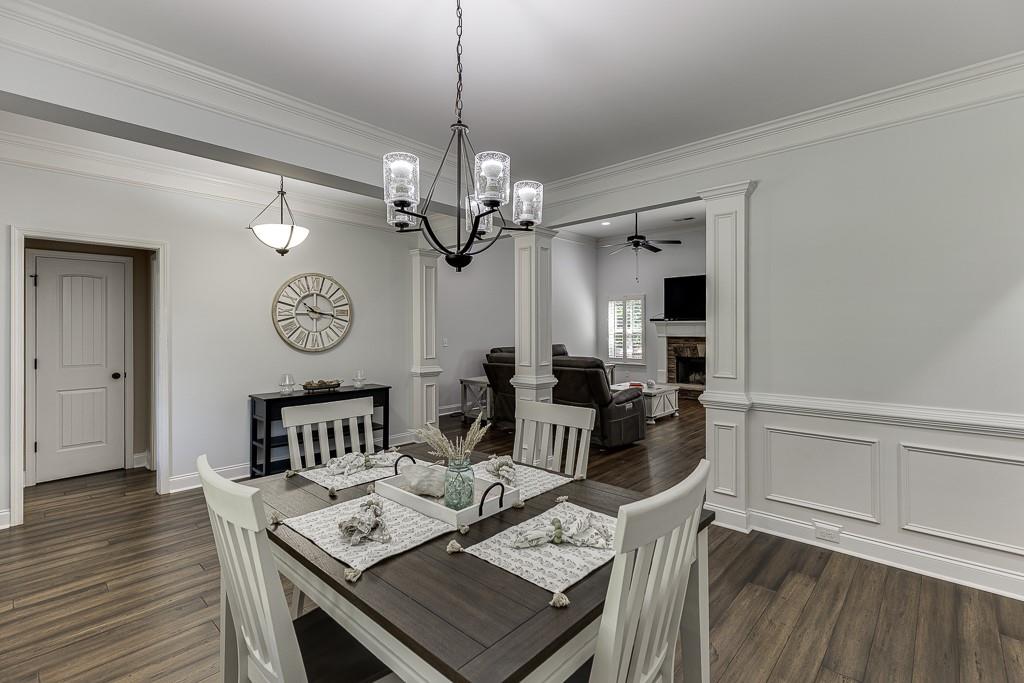 2858 Shadowstone Way Winder, GA 30680 - Photo 6 of 52 a view of a dining room and livingroom with furniture wooden floor a chandelier