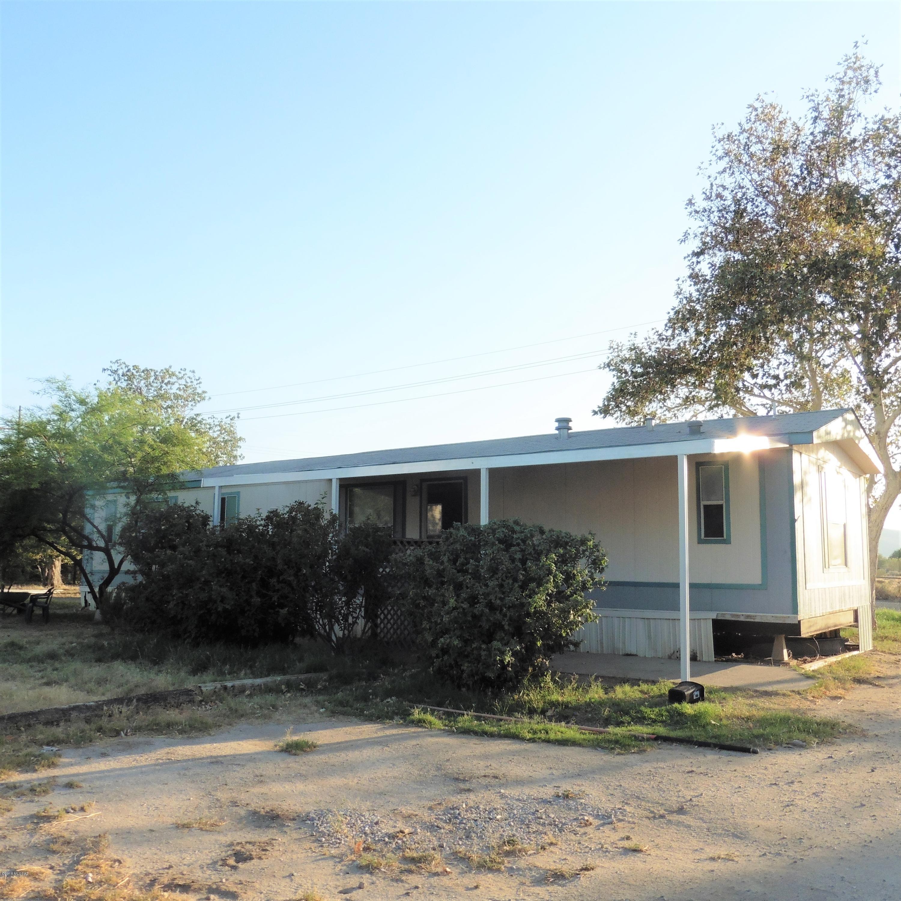 4906 West Massingale Road Tucson, AZ 85741 - Photo 2 of 17 a front view of a house with garden