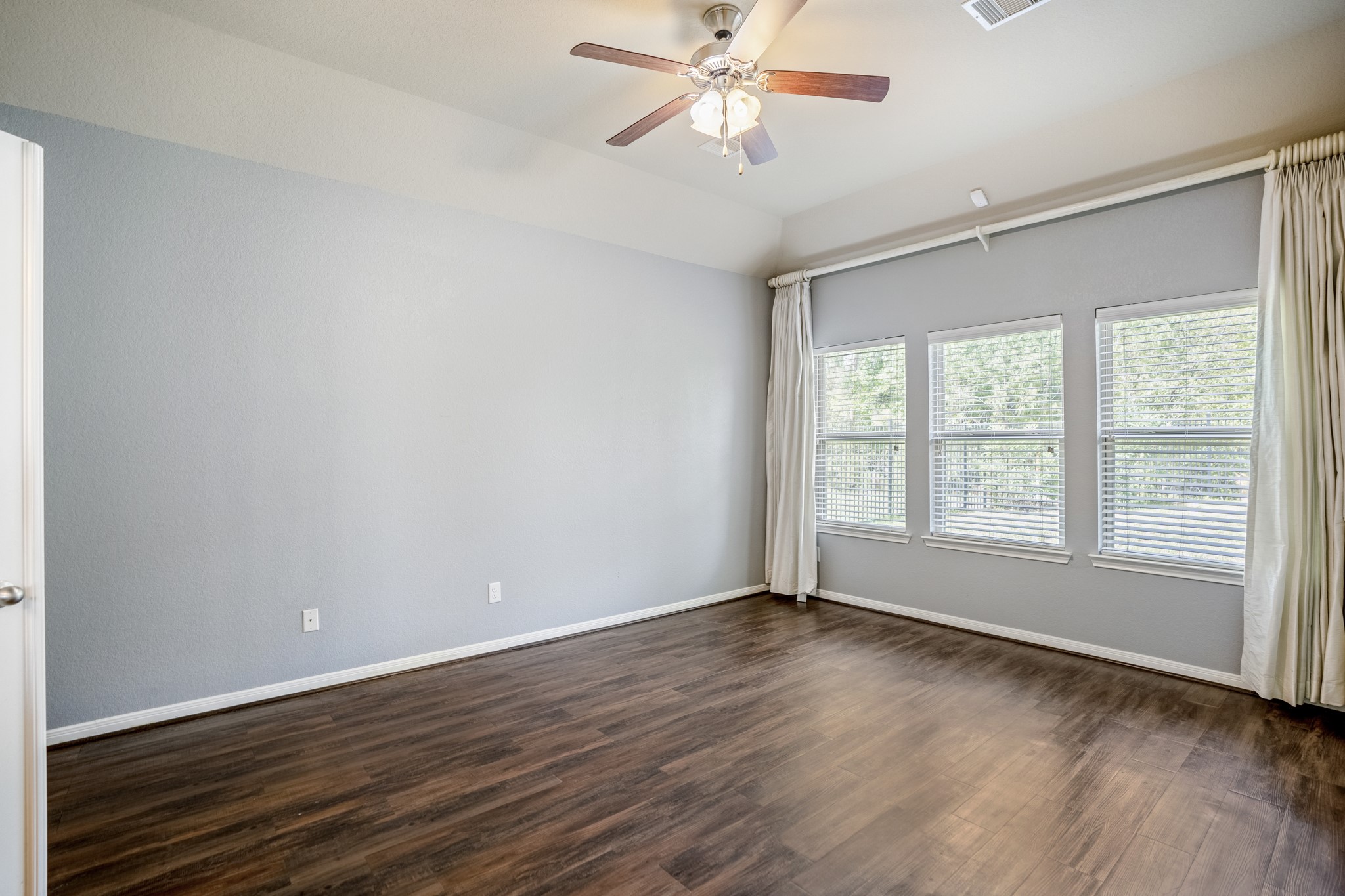 5319 Claymore Meadow Lane Spring, TX 77389 - Photo 19 of 34 a view of an empty room with wooden floor and a window