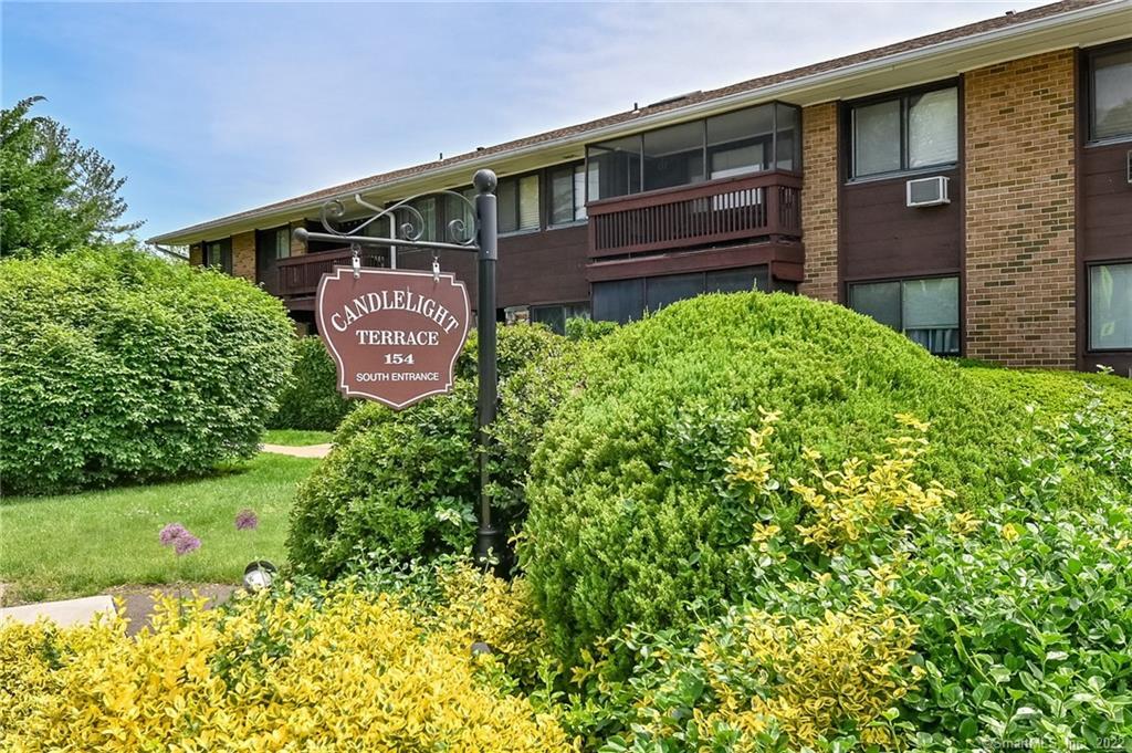 154 Cold Spring Road, Unit 64 Stamford, CT 06905 - Photo 1 of 1 a front view of a house with a yard