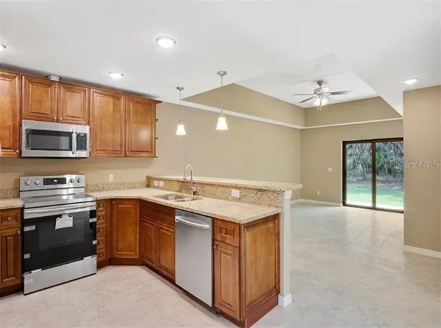 a kitchen with a sink stove and microwave