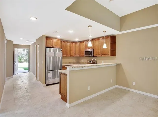 a view of kitchen with stainless steel appliances refrigerator oven