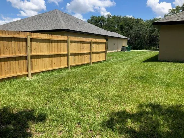 a backyard of a house with wooden fence